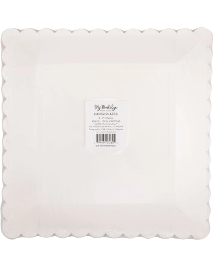 White paper plates with scalloped edge on a white background
