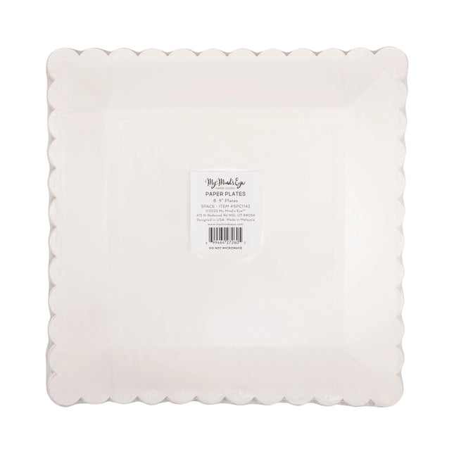 White paper plates with scalloped edge on a white background