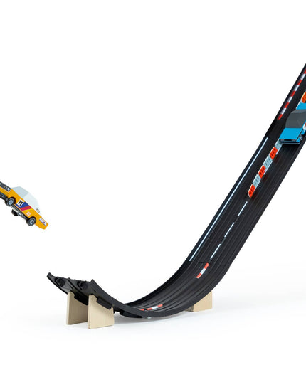 Toy race track with a car on a white background