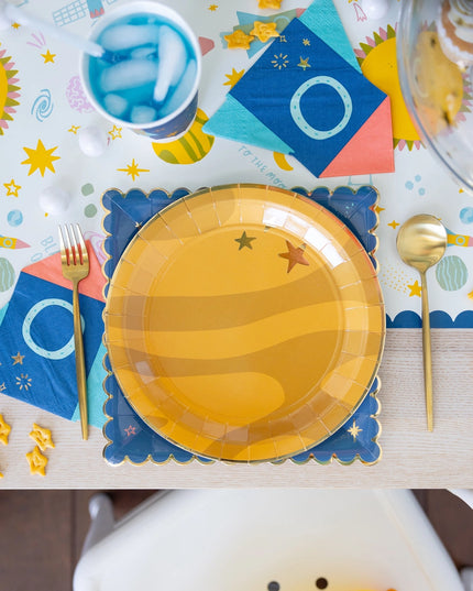 Yellow paper plate with star design on a colorful table setting