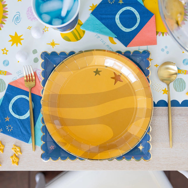 Yellow paper plate with star design on a colorful table setting